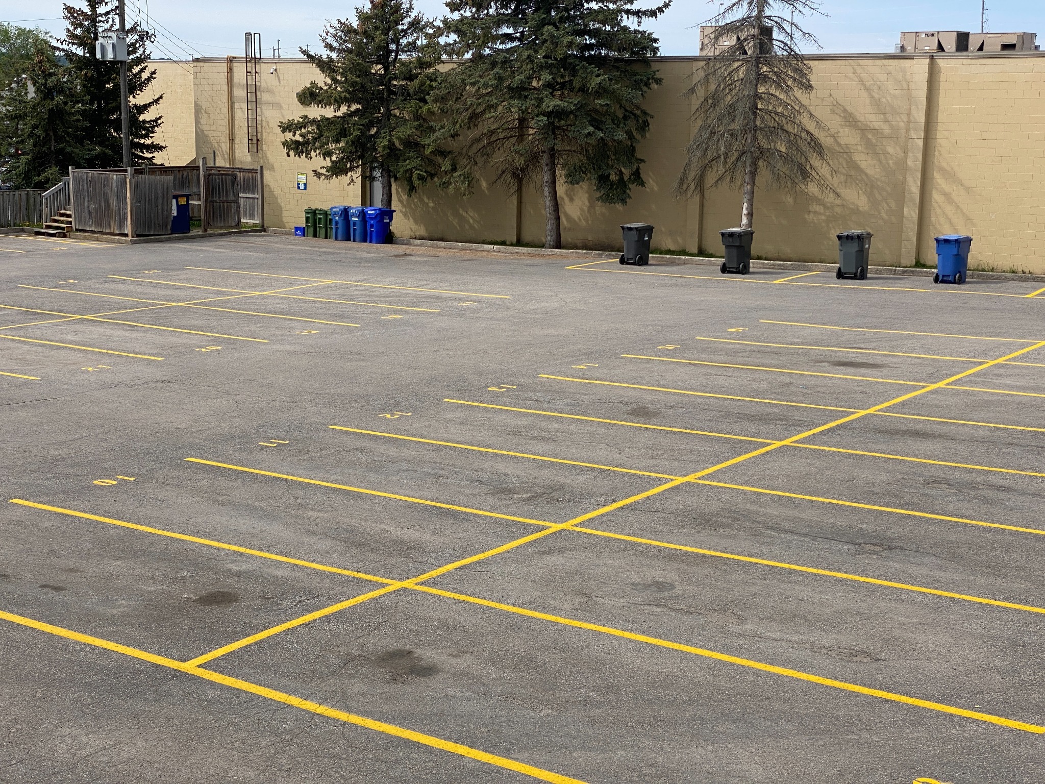 Numbered commercial parking stalls painted by Stratton’s