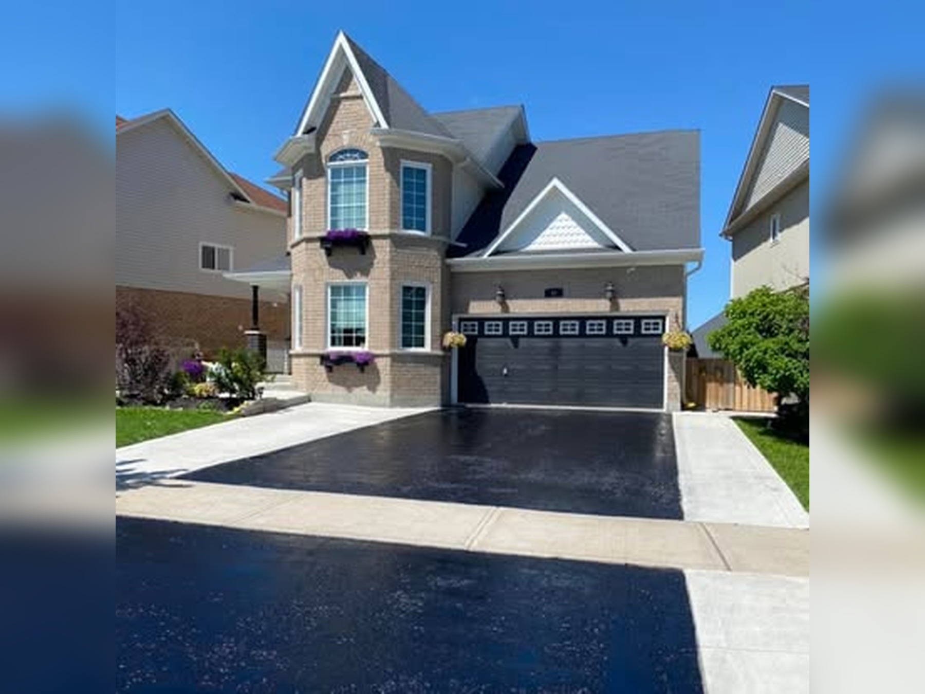Freshly sealed residential asphalt driveway completed by Stratton’s